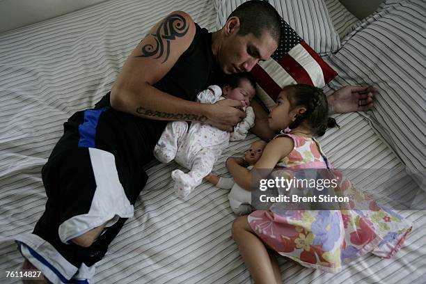 Josh Stein is pictured at home with his two daughters, new-born Jasmine and 2 year old Rachel on August 23, 2006 in San Antonio, Texas. Stein is a...