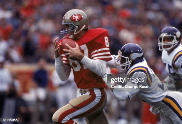 Wide receiver Dwight Clark of the San Francisco 49ers catches a pass against defensive back Rufus Bess of the Minnesota Vikings during a game at...