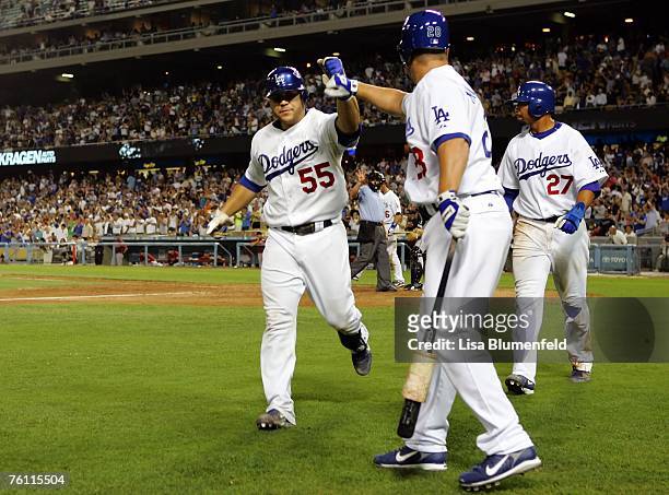 Russell Martin is congratulated by teammate Shea Hillenbrand of the Los Angeles Dodgers after hitting a two run homerun in the sixth inning against...