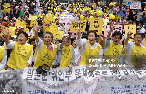 Elderly South Korean women, who were forced to serve as sax slaves for Japanese troops during World War II, lead a rally outside the Japanese embassy...