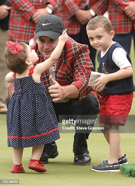 Rory Sabbatini greets his daughter on the 18th green as his son looks on after his playoff victory in the 2007 Crowne Plaza Invitational at Colonial...