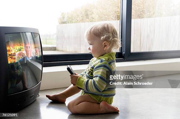 little boy watching tv - one baby boy only fotografías e imágenes de stock