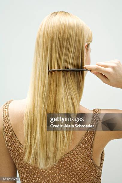 blond woman combing her hair - long blonde hair stock pictures, royalty-free photos & images