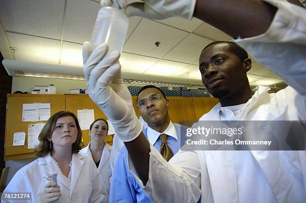 Freeman Hrabowski chats with students from the Howard Hughes Medical Institute at UMBC, where Dr. Michael Summers leads undergraduate researchers in...