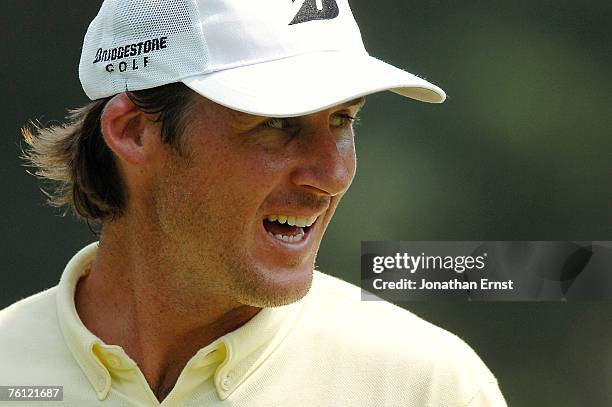 Will MacKenzie smiles on the 17th green during the first round of the Wyndham Championship at Forest Oaks Country Club on August 16, 2007 in...