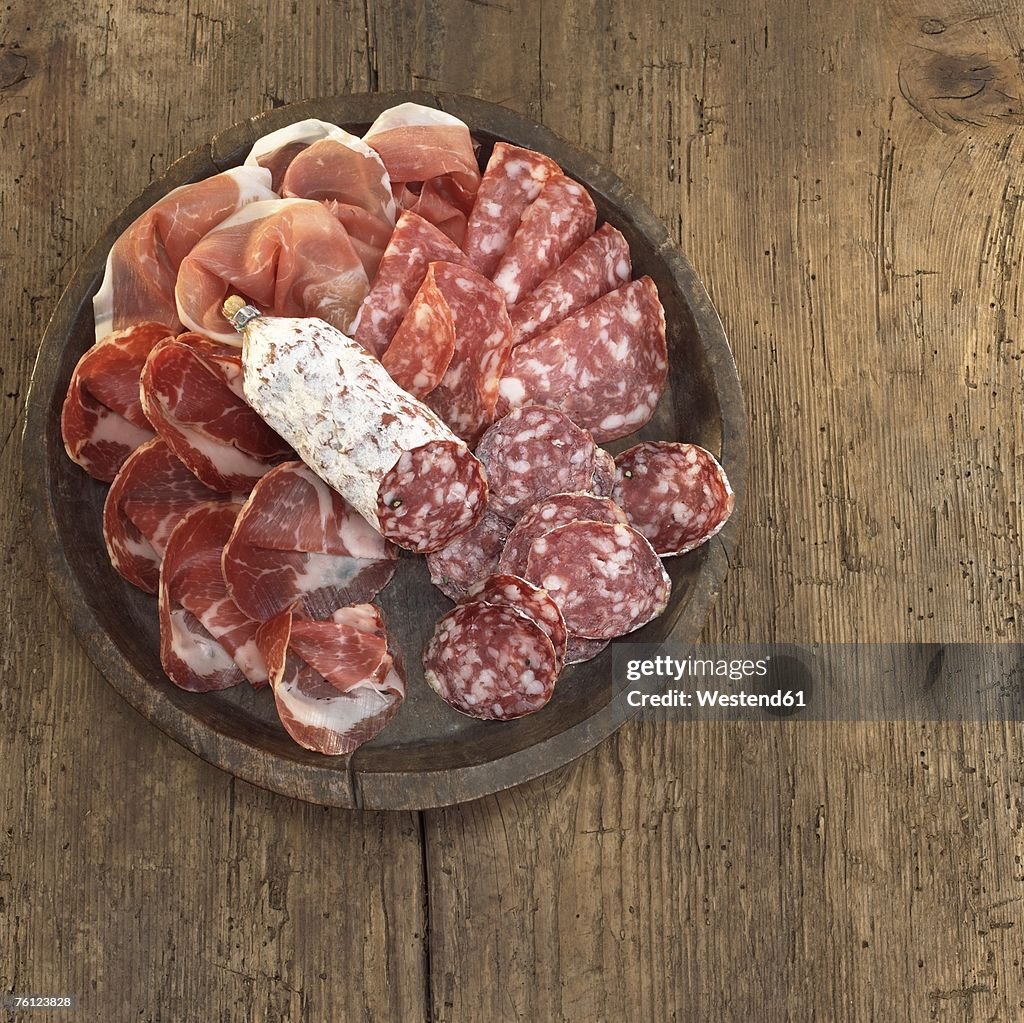 Sliced salami and ham on plate, elevated view