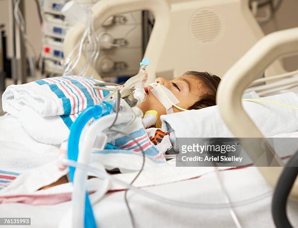 hispanic boy in intensive care unit bed - ventilator bildbanksfoton och bilder