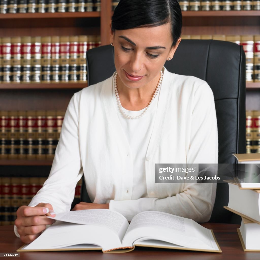 Hispanic female lawyer reading