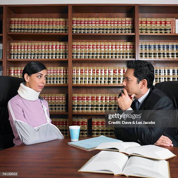 male lawyer talking to injured client - halskrause stock-fotos und bilder