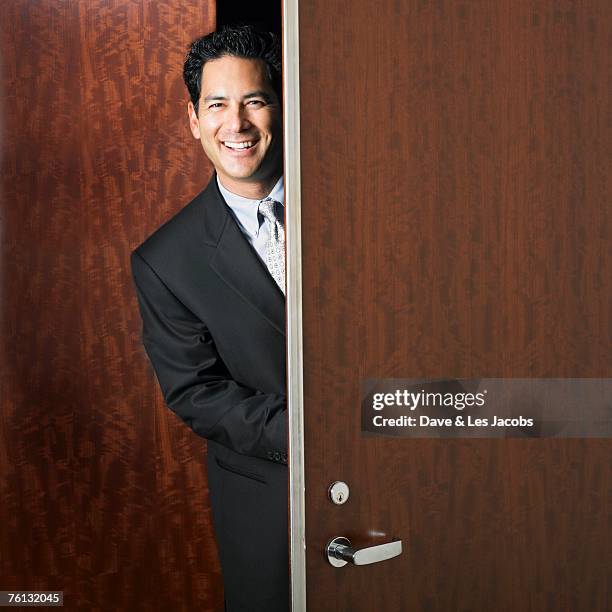 mixed race businessman walking through doorway - vorwärtsbewegung stock-fotos und bilder