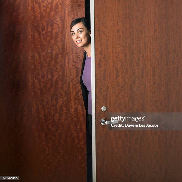 hispanic businesswoman walking through doorway - woman standing in doorway stock pictures, royalty-free photos & images