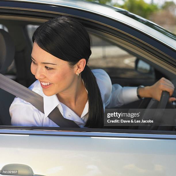 eurasian woman driving car - eurasian ethnicity stock pictures, royalty-free photos & images