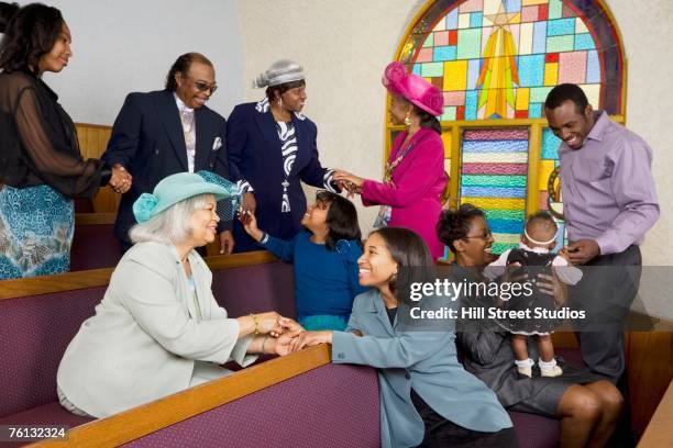 african american people holding hands in church - african american church stock pictures, royalty-free photos & images