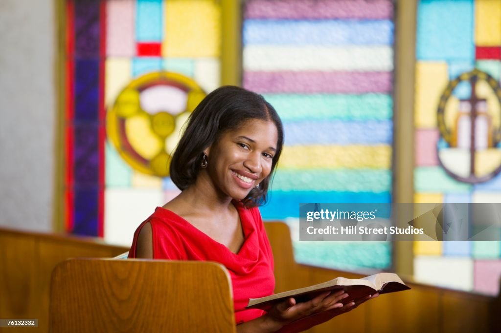 African American woman with Bible in church