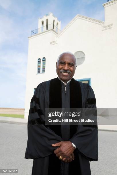 african american reverend in front of church - minister clergy photos et images de collection