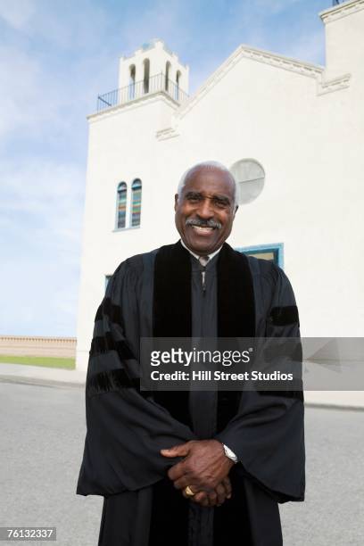 african american reverend in front of church - ministero foto e immagini stock