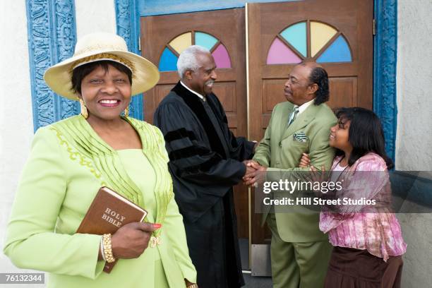 african american reverend greeting parishioners - black women in the bible stock pictures, royalty-free photos & images