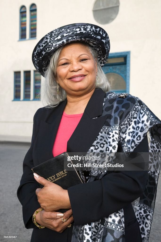 Senior African American woman in front of church