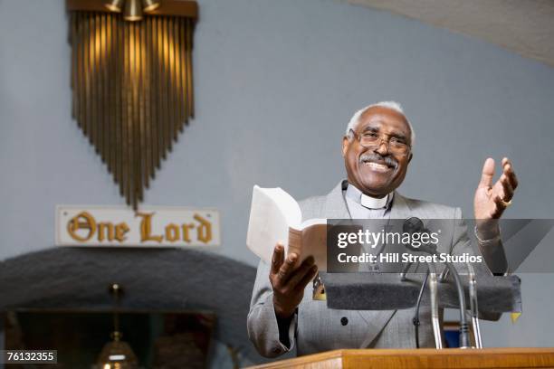 african american reverend preaching in church - vikar stock-fotos und bilder