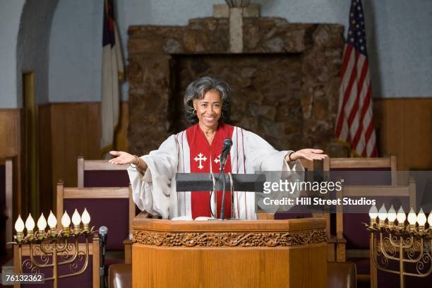 african american female reverend preaching in church - preacher stock pictures, royalty-free photos & images