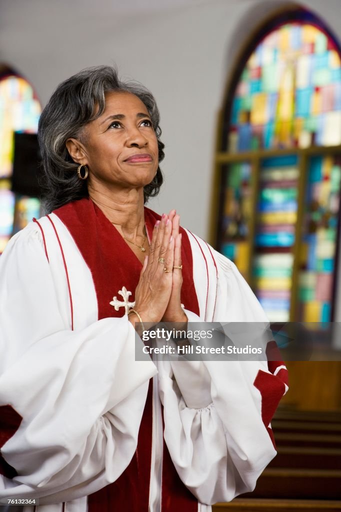 African American Female Reverend Praying High-Res Stock Photo - Getty ...
