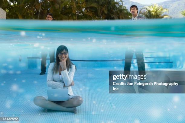 south american businesspeople in swimming pool - underwater composite image stock pictures, royalty-free photos & images