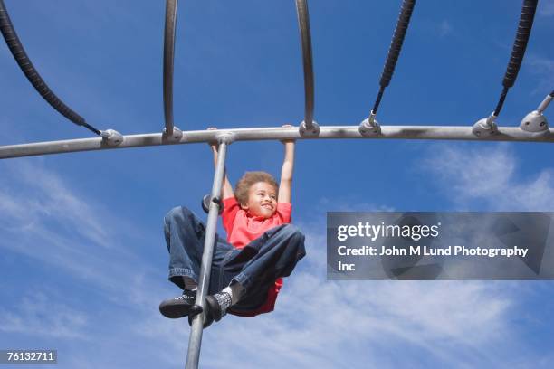 african american boy playing on jungle gym - monkey bars stock pictures, royalty-free photos & images