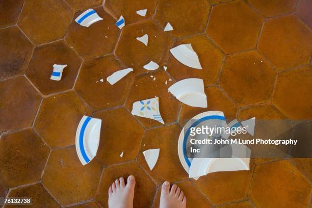 broken plate next to child's bare feet - broken plate stock pictures, royalty-free photos & images