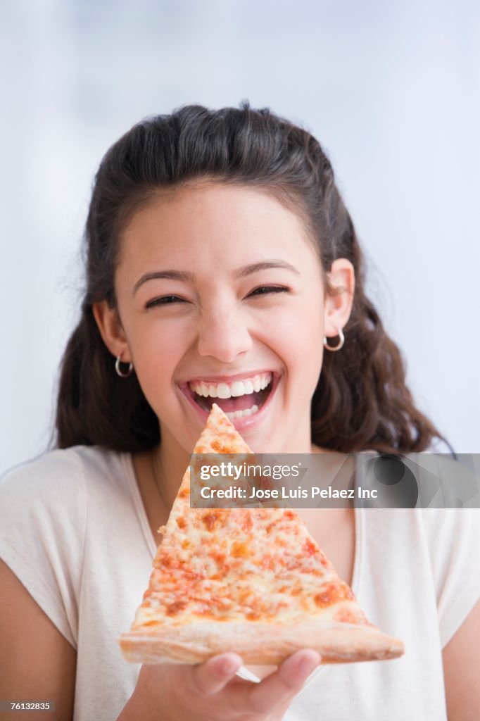 Hispanic girl eating pizza