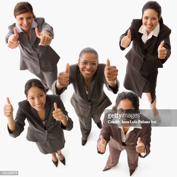 multi-ethnic businesswoman giving thumbs up - happy woman thumbs studio ストックフォトと画像