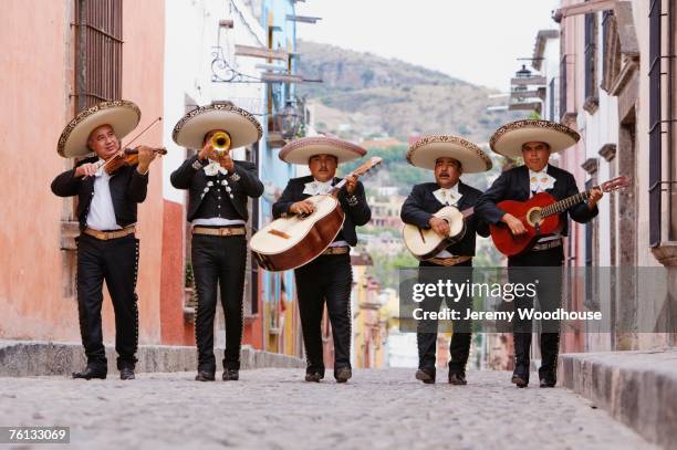 mariachi band walking in street - traditional clothing fotografías e imágenes de stock