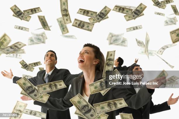 multi-ethnic businesspeople under rain of money - catching money stock pictures, royalty-free photos & images