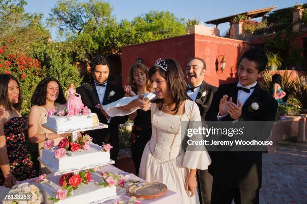 hispanic girl eating cake at quinceanera - quinceañera fotografías e imágenes de stock