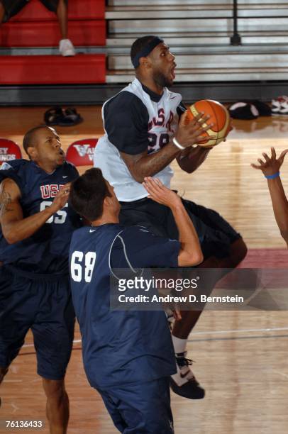 LeBron James of the USA Basketball Men's Senior National Team goes to the hoop against Andre Iguodala of the USA Basketball Mens Select Team during...