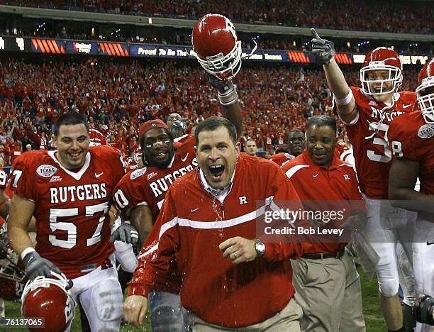 Rutgers head coach Greg Schiano reacts to getting dumped with water after their victory. The Scarlet Knights beat the Panthers 37-10 in the inaugural...