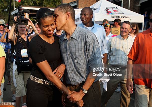 Democratic Presidential Candidate Senator Barack Obama gives his wife Michelle a playful kiss as they tour the Iowa State Fair August 16, 2007 in Des...