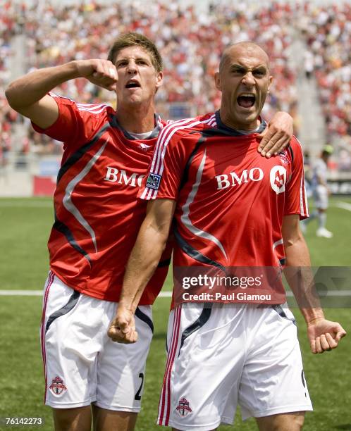 Toronto FC defender Andrew Boyens and forward Danny Dichio in celebration of the second goal of the match during the game against FC Dallas at BMO...