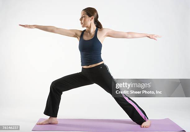 young woman doing yoga, studio shot - yoga studio shot stock pictures, royalty-free photos & images