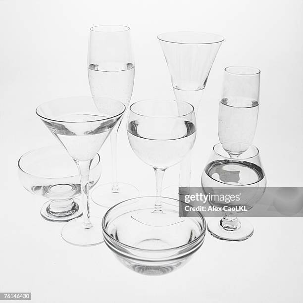 arrangement of glasses filled with water - brandy snifter stock pictures, royalty-free photos & images