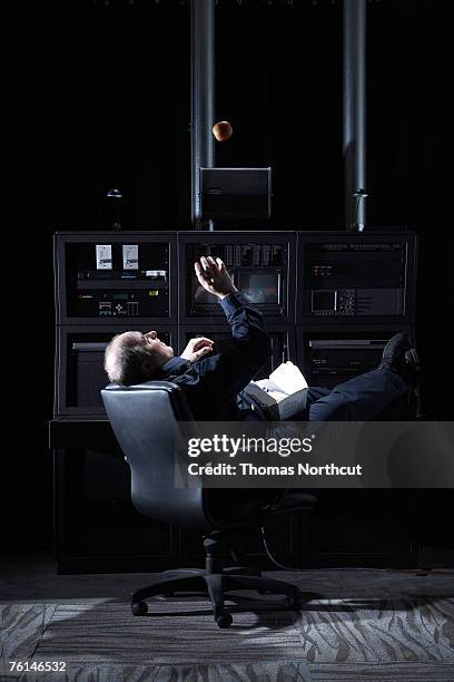 security guard tossing apple in office - bewaken stockfoto's en -beelden