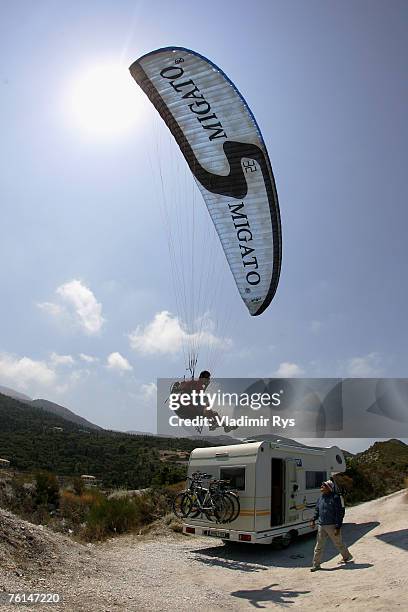 Paragliding fan Giannis Chiros from Greece tries to land on a roof of a car near by Kathisma beach on August 2, 2007 on Lefkada island, Greece.