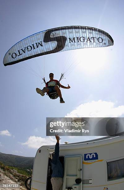 Paragliding fan Giannis Chiros from Greece tries to land on a roof of a car near by Kathisma beach on August 2, 2007 on Lefkada island, Greece.