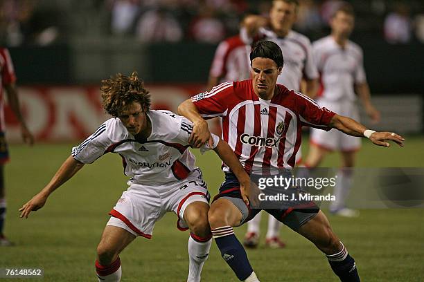 Alex Zotinca of Chivas USA and Wells Thompson of the New England Revolution battle for position during their MLS match June 30, 2007 at the Home...