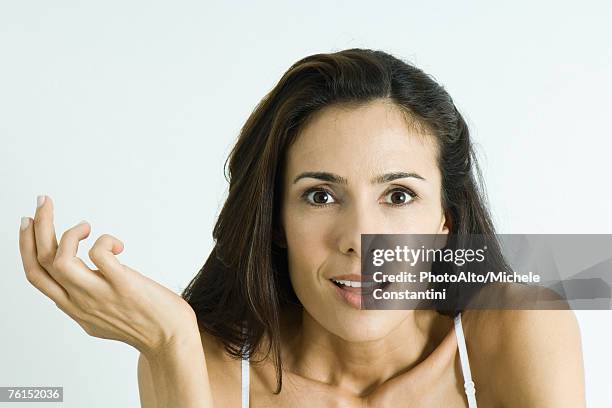 "woman making surprised face, holding up hand, portrait" - mujeres de mediana edad fotografías e imágenes de stock