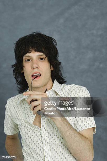 "teen boy holding sunglasses to lip, looking at camera, portrait" - mullet haircut stock pictures, royalty-free photos & images