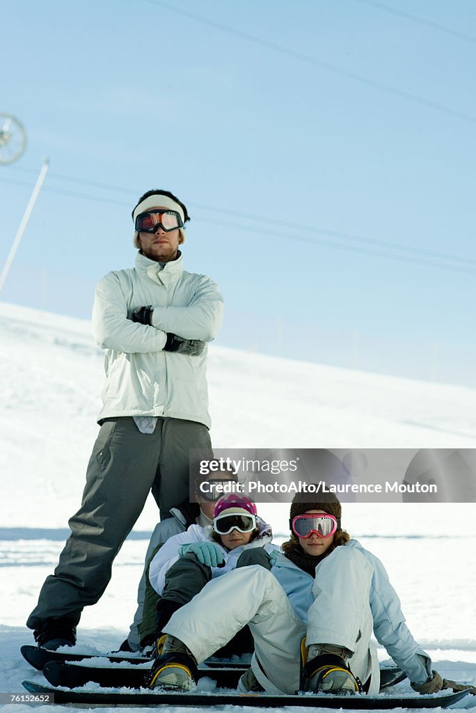 "Young snowboarders on ski slope, full length portrait  "