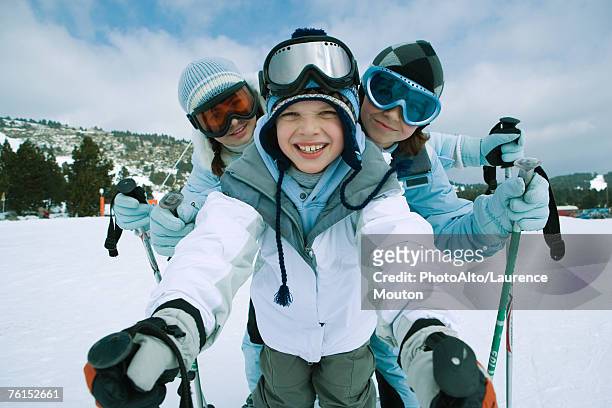 "young skiers standing on ski slope, portrait" - ski closeup stock-fotos und bilder
