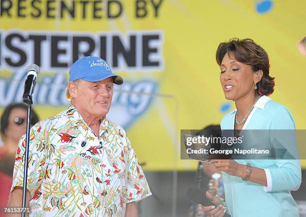 Beach boys member Bruce Johnston gives a copy of the groups new CD to Robin Roberts during the "Good Morning America" Concert Series in Bryant Park...