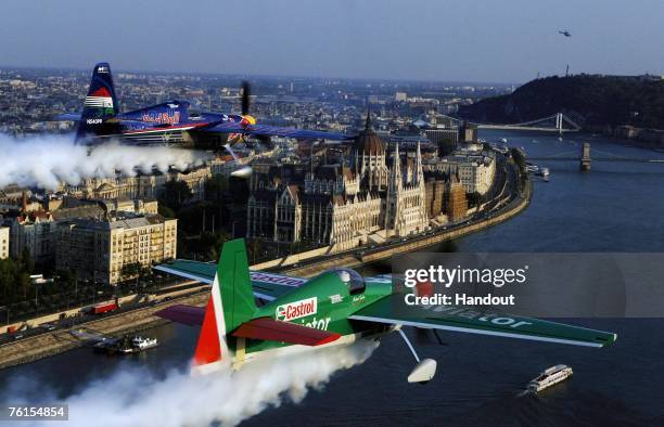 In this handout image supplied by Sports&News, Hungarian pilot Peter Besenyei of Team Red Bull and American pilot Mike Goulian of Dragon Racing take...