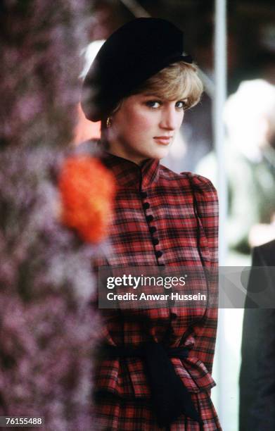 Diana, Princess of Wales, wearing a tartan dress designed by Caroline Charles and a black Tam o' shanter style hat, attends the Braemar Highland...